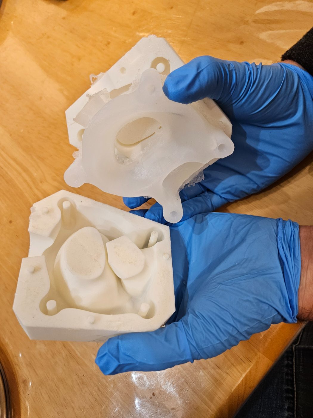Two halves of a 3D-printed mold for a silicone anatomical cast